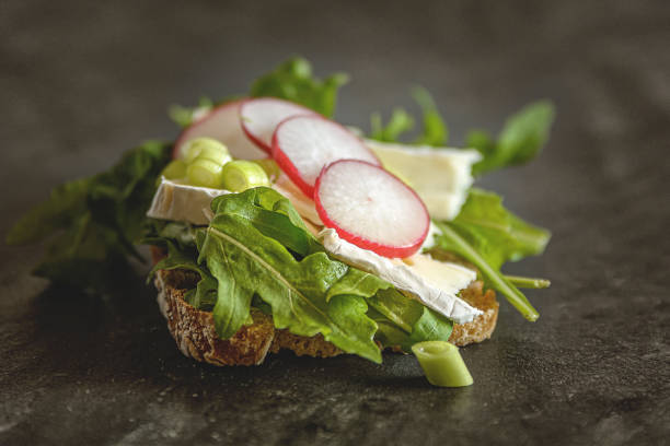 A slice of bread topped with cheese and salad